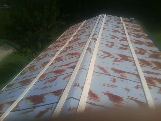 Rusted metal roof panels with new wood purlins before replacement — Storm Damage Roof Repair in Gouldsboro by Roofing Brothers