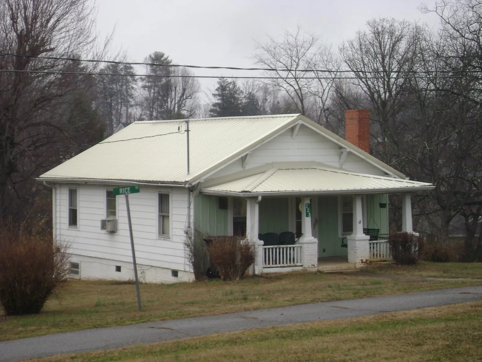 White metal roof on a craftsman bungalow at a street corner in Gouldsboro